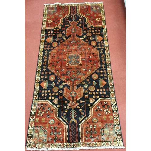 242 - A blue ground Persian Rug with unique medallion design and multi borders. 245 x 110cm approx.