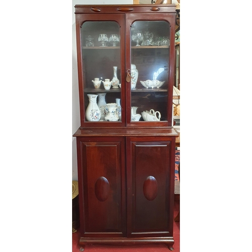 272 - A good early 20th Century Mahogany twin door cabinet with glazed upper section and panel door base. ... 