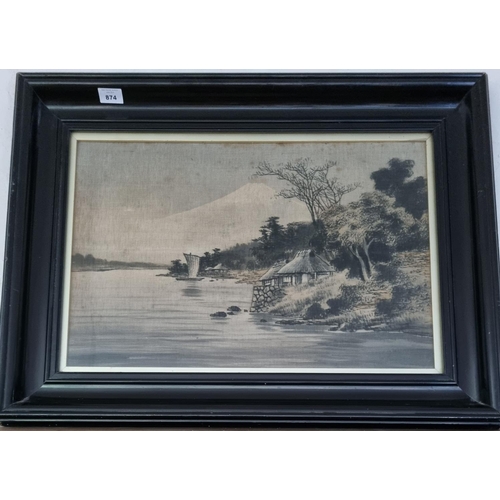 369 - An Oriental Picture laid on Silk of a lake scene in a good ebonised frame. 36 x 54 cm approx.