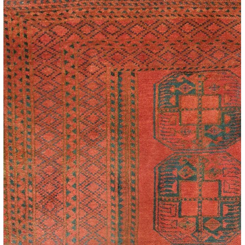 416 - A large Red ground Persian Carpet with repeating central medallion design, faded at one end.
L 327 x... 