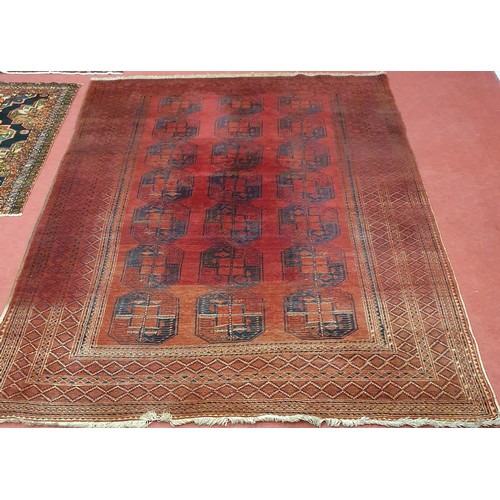 416 - A large Red ground Persian Carpet with repeating central medallion design, faded at one end.
L 327 x... 