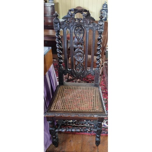 429 - A 19th Century Oak Hall Chair with cane seat and highly carved back. W46 x SH45 x BH108cm approx.