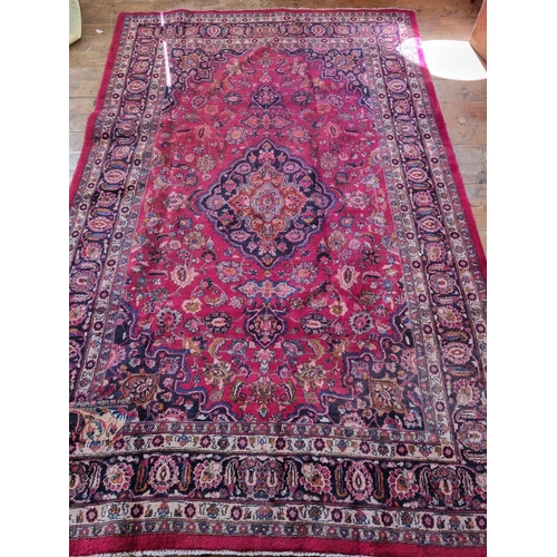 440 - A Vintage Red ground Iranian Carpet with a floral medallion design from the Masher region of Iran.  ... 