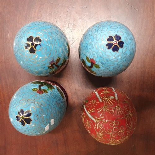 461 - A cased set of four Chinese cloisonne Enamel Eggs each with floral decoration on an ebonised stand. ... 