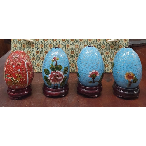 461 - A cased set of four Chinese cloisonne Enamel Eggs each with floral decoration on an ebonised stand. ... 