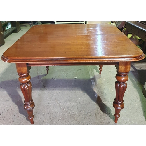 997 - A Victorian Mahogany Dining Table .