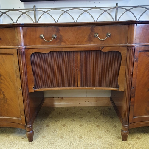 39 - A Fabulous 19th Century Mahogany concave Sideboard with a tambour door and single frieze concave cen... 