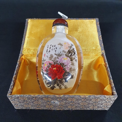 496 - Of fine quantity a Chinese painted glass snuff Bottle of flask form decorated with a floral bouquet ... 