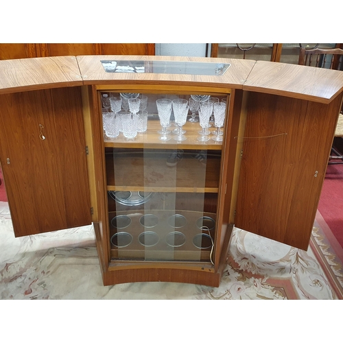 544 - A very unusual mid century Drinks Cabinet with curved flip top counter and sliding glazed doors with... 