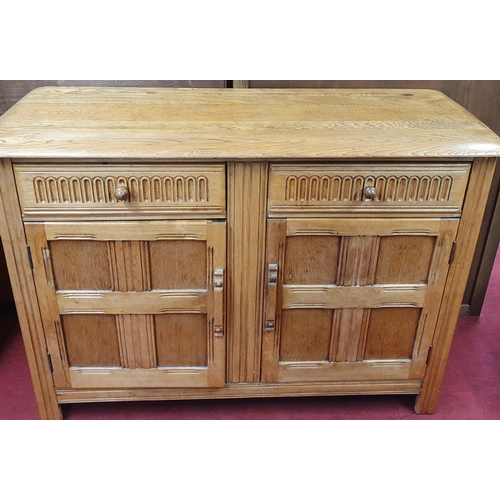 564 - A Mid Century Oak two door Cabinet with twin frieze drawer. 120 x 45 x H 86 cm approx.