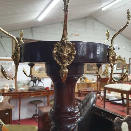 579 - A good Mahogany Circular Coat and Stick Stand with barley twist supports and tripod base with lions ... 