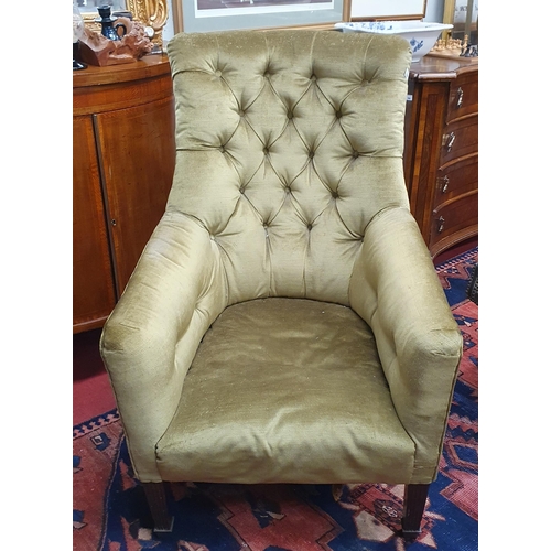 584 - A good early 19th Century Mahogany Armchair with deep buttoned back and reeded front supports on bra... 