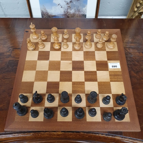 590 - A Mahogany and Veneered Chess Board with timber turned pieces. 35 x 35 cm approx.