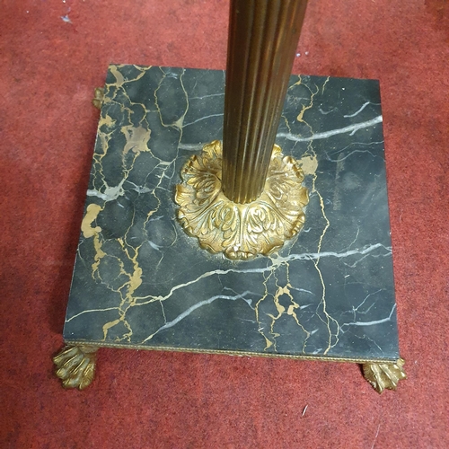 596 - A good Brass and Marble Standard Lamp with paw feet.