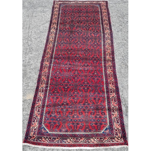 1097 - A handwoven Persian red ground village Runner from the Hamadan region 280 x 101 cm approx.