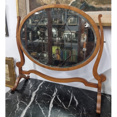 887 - An Edwardian Mahogany oval Crutch Mirror with bevelled mirror glass. W 61 x H 56 cm approx.