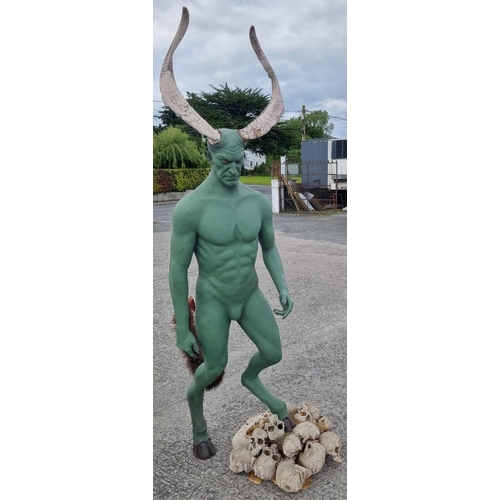 A tall reasonably well endowed horny green Man standing on a bed of Skulls.
Height 240 cm approx.