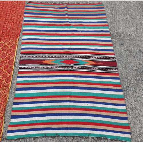 195 - A Group of Rugs , 2 Cushion Covers, 2 non slips under rugs  and a length of red and gold Fabric.