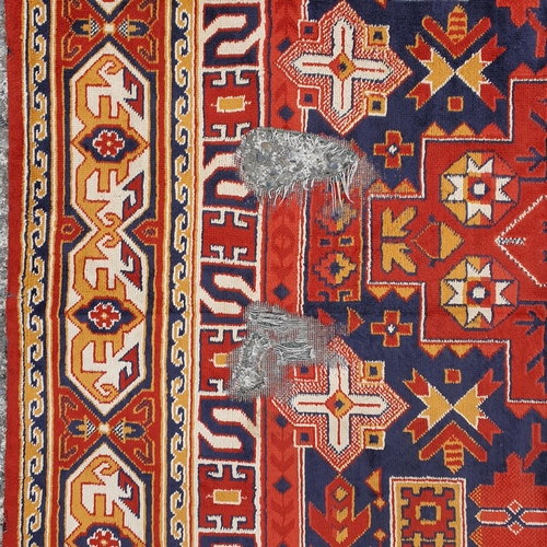 197 - A rust and blue ground Carpet.
L 280 x W 1447 cm approx.