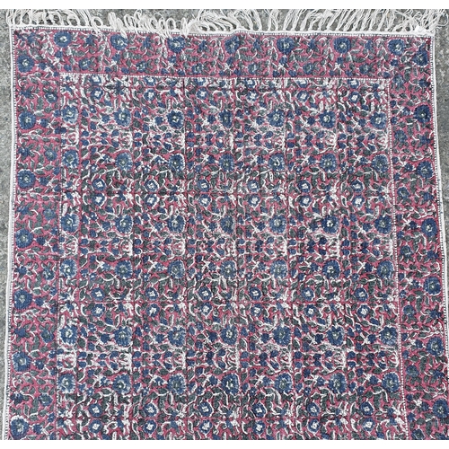 198 - A pink and blue ground Rug.
L 190 x W 120 cm approx.