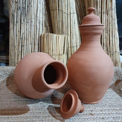 379 - A Pair of Lidded Clay Pottery Urns .
Height 50 cm approx.