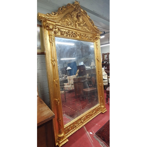 13 - An extremely large Plaster and Gilt Overmantel Mirror with lions head top bevelled edge glass and hi... 