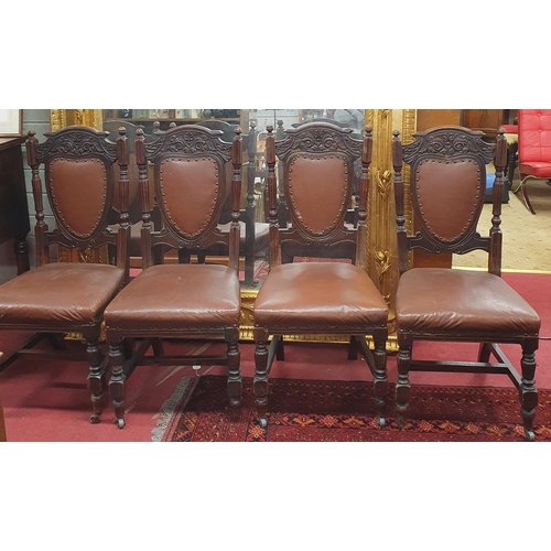 14 - A set of four late 19th early 20th Century Walnut Dining Chairs with padded upholstered backs and se... 
