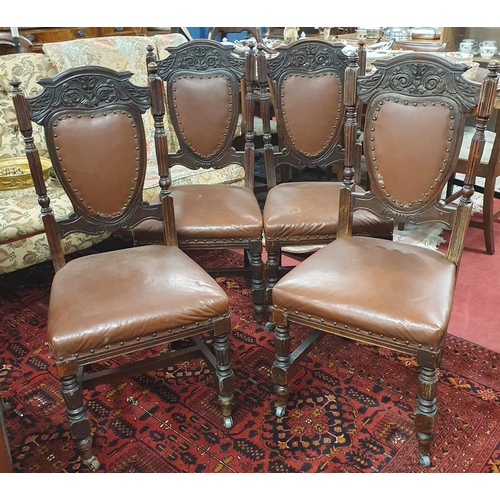 14 - A set of four late 19th early 20th Century Walnut Dining Chairs with padded upholstered backs and se... 