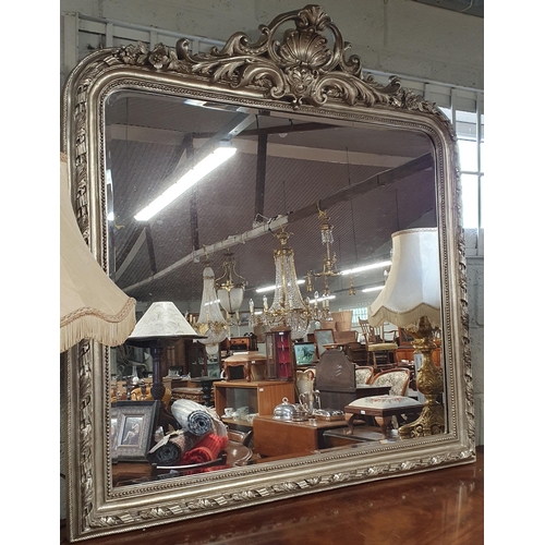 82 - A good silvered Arch top Mirror with highly moulded cartouche top with leaf and rope edge surround w... 