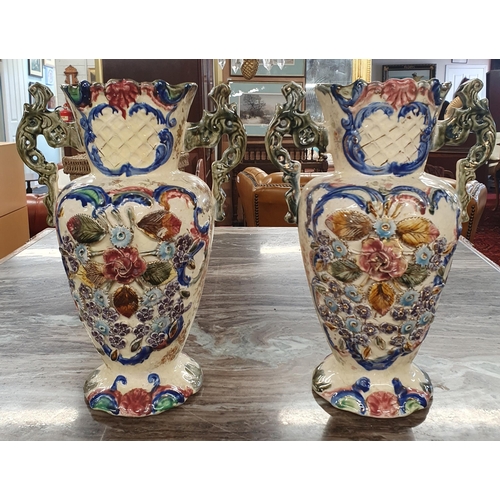 170 - Two good Pottery Vases profusely decorated with floral design. H 32 cm approx.