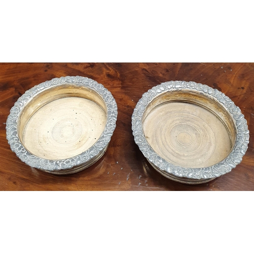 189 - A pair of Silver Plated Coasters with timber bases along with a highly pierced silver plated bottle ... 