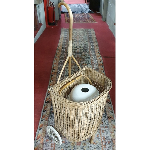 193 - A Lloyd Loom Linen Basket along with an unusual vintage 19th Century wicker trolley and a ceramic po... 