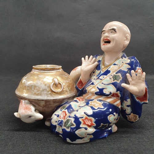 195 - A 19th Century Oriental Figure of a man beside a lidded dish with hand painted decoration. W 16 x H ... 