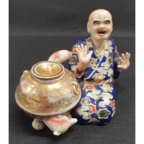 195 - A 19th Century Oriental Figure of a man beside a lidded dish with hand painted decoration. W 16 x H ... 