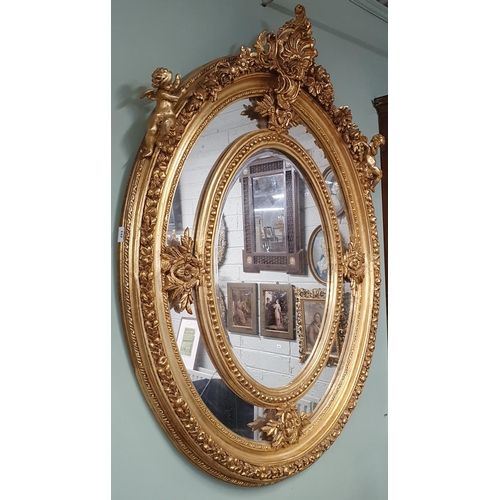 253 - A Fantastic timber and Plaster Gilt oval Mirror with bevelled edge centre and highly carved and moul... 