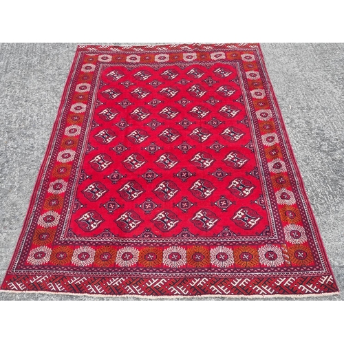 1096 - A Red ground Turkmen Carpet with an all over Bokhara design. 295 x 200 cm approx.