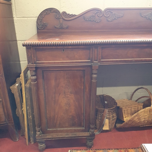 84 - An early 19th Century Mahogany Sideboard with highly carved back on turned reeded supports. 201 x 64... 