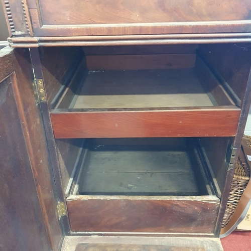 84 - An early 19th Century Mahogany Sideboard with highly carved back on turned reeded supports. 201 x 64... 