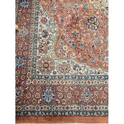 860 - A Terracotta ground Persian design Carpet, 100% wool with a traditional medallion design, 400 x 300 ... 