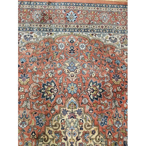 860 - A Terracotta ground Persian design Carpet, 100% wool with a traditional medallion design, 400 x 300 ... 