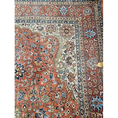 860 - A Terracotta ground Persian design Carpet, 100% wool with a traditional medallion design, 400 x 300 ... 