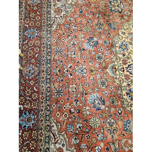 860 - A Terracotta ground Persian design Carpet, 100% wool with a traditional medallion design, 400 x 300 ... 