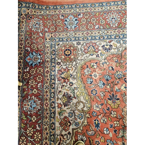 860 - A Terracotta ground Persian design Carpet, 100% wool with a traditional medallion design, 400 x 300 ... 