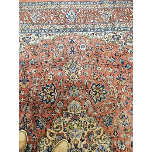 860 - A Terracotta ground Persian design Carpet, 100% wool with a traditional medallion design, 400 x 300 ... 