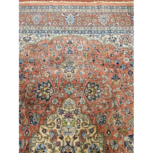 860 - A Terracotta ground Persian design Carpet, 100% wool with a traditional medallion design, 400 x 300 ... 