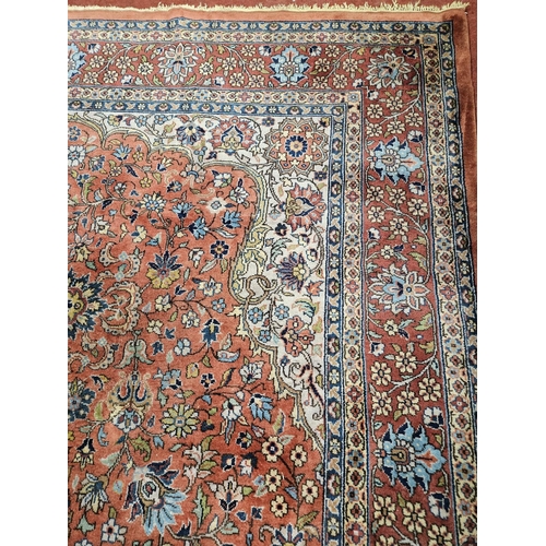 860 - A Terracotta ground Persian design Carpet, 100% wool with a traditional medallion design, 400 x 300 ... 