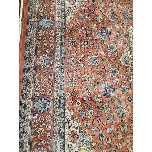 860 - A Terracotta ground Persian design Carpet, 100% wool with a traditional medallion design, 400 x 300 ... 