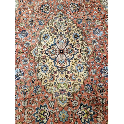 860 - A Terracotta ground Persian design Carpet, 100% wool with a traditional medallion design, 400 x 300 ... 