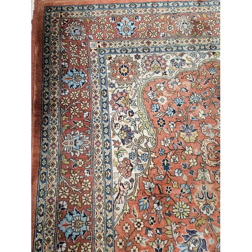 860 - A Terracotta ground Persian design Carpet, 100% wool with a traditional medallion design, 400 x 300 ... 