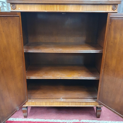 268 - A 20th Century Mahogany two door Cabinet with adjustable shelving and brass grill front and brass ga... 